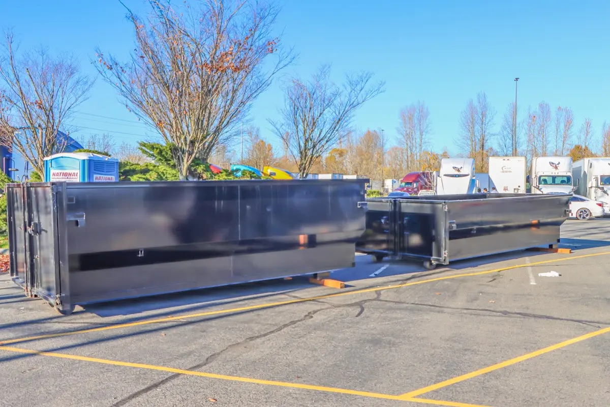 Professional dumpster rental service with roll-off container on residential driveway in Towson